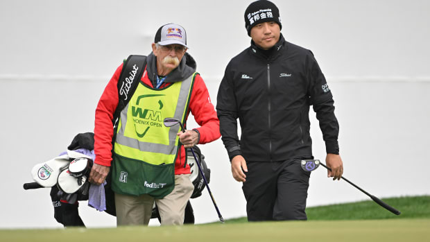 Mike “Fluff” Cowan caddies for  C.T. Pan at the WM Phoenix Open.